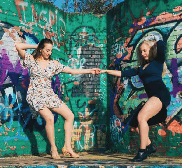 Instagram photo of Natalia Eristavi dancing with another dancer in front of a graffiti wall